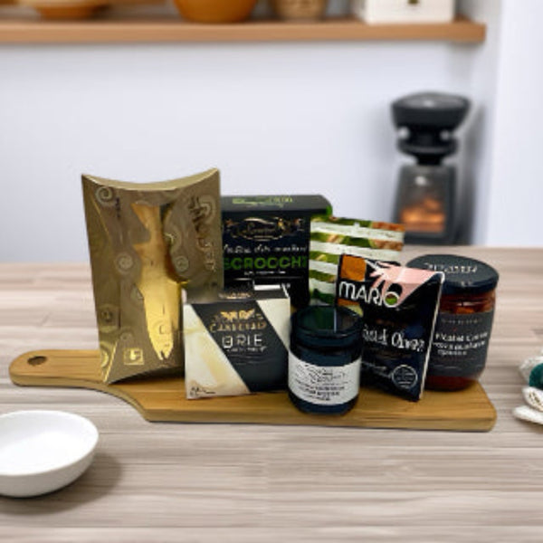 Bamboo board with smoked salmon, crackers, nuts, cheese, olives, marinated carrots, and savoury spread. Thoughtful Gift Baskets in Ottawa