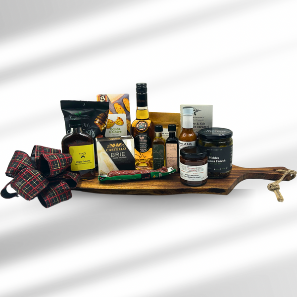 large Acacia board with award winning whisky, chips, crackers, local spreads, cheese, infused olive oil and balsamic vinegar, cured sausage, hot sauce, pickles, maple syrup and local chocolate.  Charcuterie Gift baskets in Ottawa