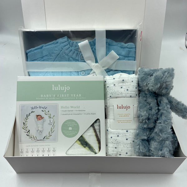 Baby gift set with knitted sweater and hat, blanket, Baby's first year card/blanket set, and plush toy.