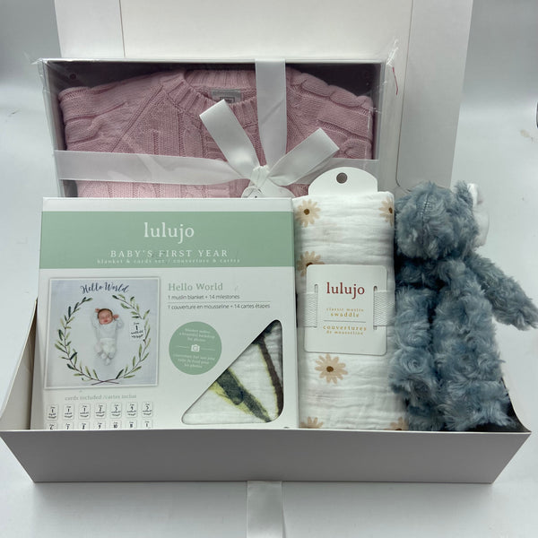Baby gift set with knitted sweater and hat, blanket, Baby's first year card/blanket set, and plush toy.