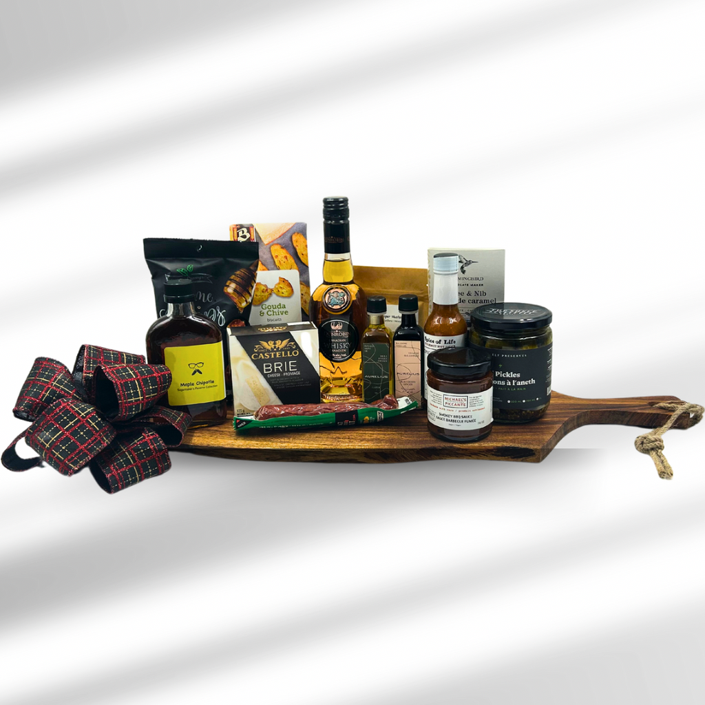 Indulge in a handpicked selection of gourmet delights with the Artisan Feast gift basket.  This luxurious gift features a stunning acacia live-edge cutting board hand crafted in India, as the perfect base for an array of local treasures.  Savour the bold flavours of premium preserves, smooth cheese, cured sausage and award winning whisky from Dunrobin Distilleries.  Drizzle the locally sourced olive oil and vinegar over fresh creations, while the zesty hot sauce add a touch of spice.  