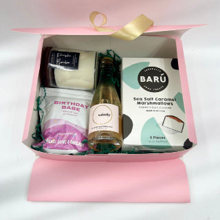 Celebrate in style with the Birthday Bliss Box—a fun mix of treats to make any birthday unforgettable. Inside, you'll find indulgent chocolate-covered marshmallows, a refreshing bottle of sparkling wine, a lightly scented all-natural candle to set the mood, and playful “Birthday Babe” bath salts for the ultimate pampering experience. This gift box is perfect for unwinding, indulging, and making birthday memories extra special.