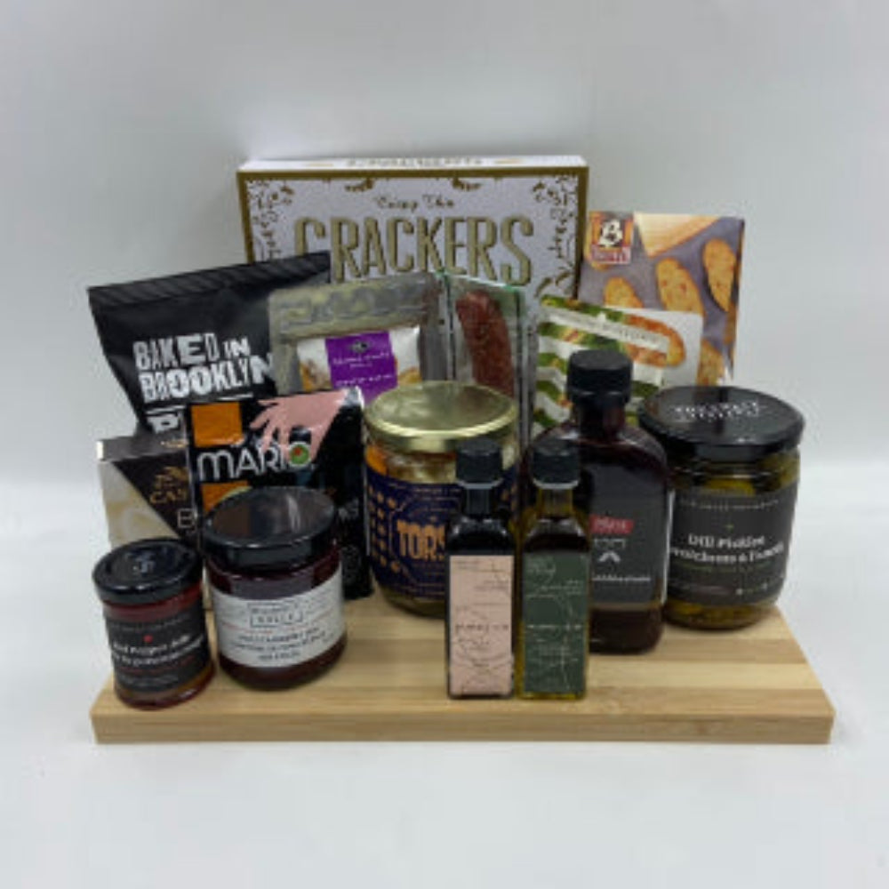 An everyday collection favourite, The Charcuterie Board brings together premium flavours on a beautifully crafted bamboo cutting board. Featuring a curated mix of crackers, locally infused olive oil and balsamic vinegar, savoury spreads, marinated vegetables, artisan cheese, cured sausage, gourmet nuts, dip mix, dill pickles, olives, and a locally crafted hot sauce. Realtor Gift Baskets in Ottawa. Anniversary Gifts in Ottawa