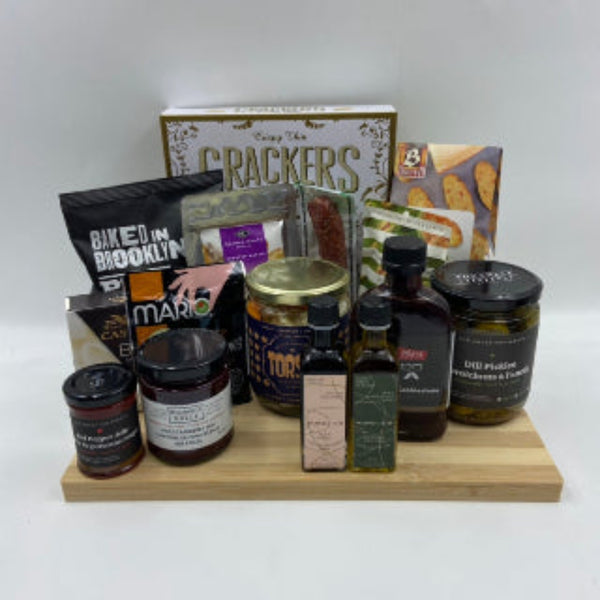 An everyday collection favourite, The Charcuterie Board brings together premium flavours on a beautifully crafted bamboo cutting board. Featuring a curated mix of crackers, locally infused olive oil and balsamic vinegar, savoury spreads, marinated vegetables, artisan cheese, cured sausage, gourmet nuts, dip mix, dill pickles, olives, and a locally crafted hot sauce. Realtor Gift Baskets in Ottawa. Anniversary Gifts in Ottawa