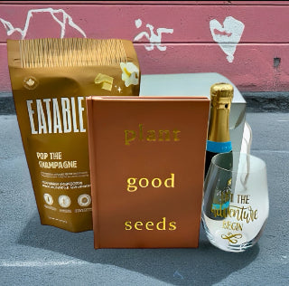 Eatable popcorn, journal, bubbly and 'let the adventures begin' stemless glass