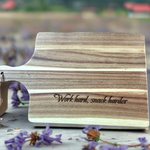 Wooden Acacia cutting board with 'Work hard, snack harder' engraving.  Cusomize with your own message or logo for a great corporate gift in Ottawa