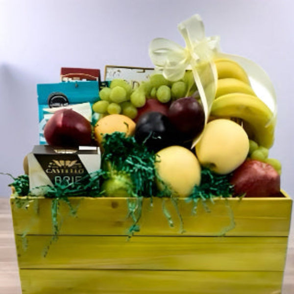 Our wooden crate filled with a selection of fresh fruit, cheese, crackers, nuts and chocolate