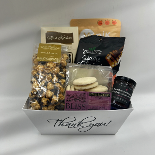 Our Gratitude in Every Bite basket is a delicious way to say "thank you." Filled with handmade shortbread, crisp chips, buttery buttercrunch, dried fruit, local jam, and chocolate-drizzled popcorn, this collection of treats is designed to show appreciation in the sweetest way. Perfect for sharing or savoring solo, it’s a thoughtful gesture that will leave a lasting impression.