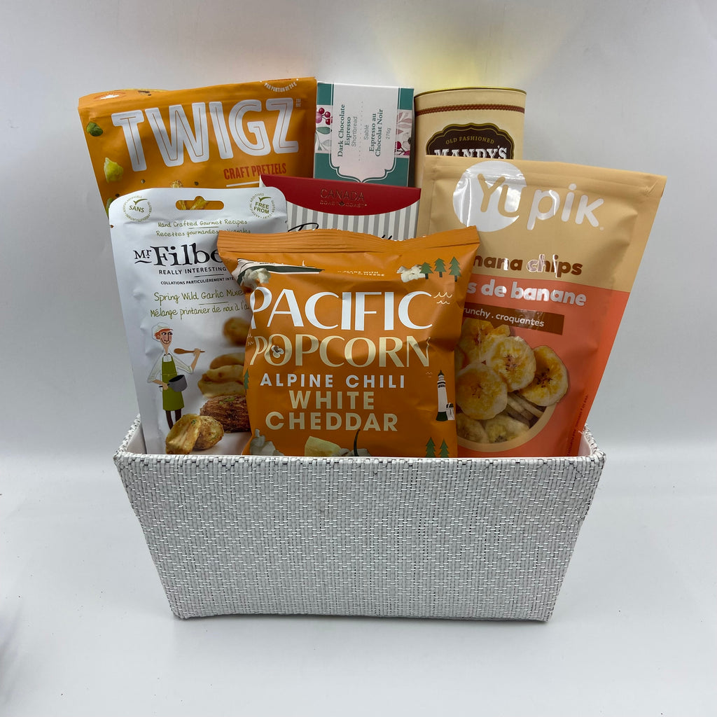 Treat someone special to a delightful mix of treats, perfect for any time of year. In a reusable container, this basket is filled with a satisfying assortment: handmade shortbread, biscotti, cookies, dried fruit, nuts, popcorn, and pretzels. Whether it's for a cozy night in or a thoughtful gift, Snacktime Harmony is crafted to bring smiles and enjoyment with every bite.