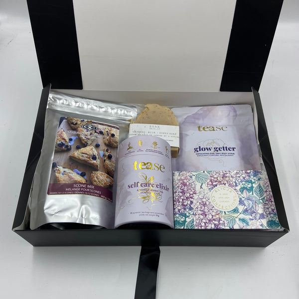 Indulge in a moment of calm with The Tranquility Treat Box, a beautifully curated gift box from our everyday collection designed to nourish body and soul. This thoughtful selection includes a delightful scone mix, a soothing Earl Grey all-natural body scrub, a self-care blend of gourmet tea, a decadent chocolate bar, and a luxurious all-natural soap bar. Perfect for unwinding, this gift is ideal for those who cherish life’s little luxuries and a touch of self-care.