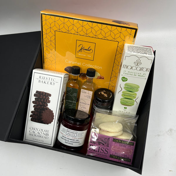 gift box is filled with an indulgent selection of premium chocolates, buttery shortbread, delicate macarons, locally infused olive oil and balsamic vinegar, and handcrafted jams.