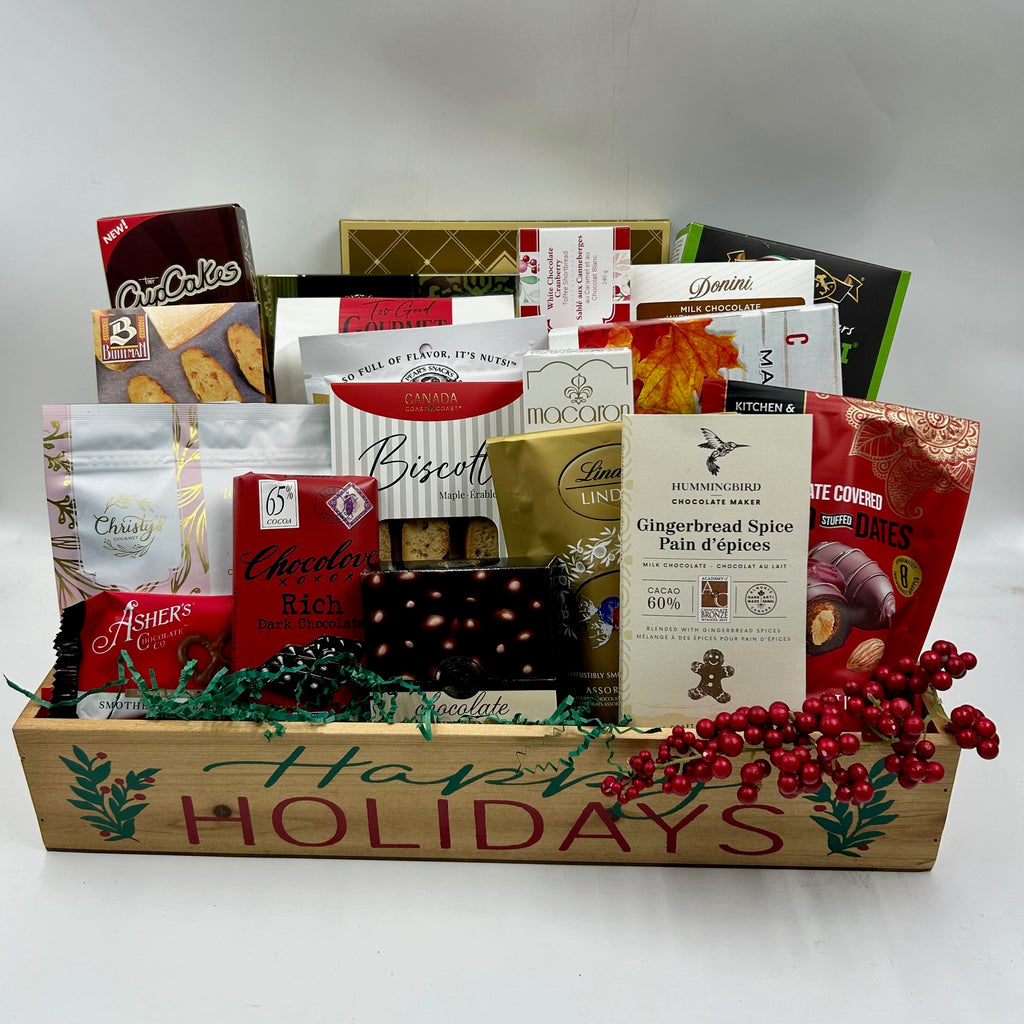 Perfect for sharing at home or the office, our Happy Holiday Basket is filled with a selection of seasonal treats crafted to satisfy every taste. This festive collection includes an assortment of cookies, rich chocolates, gourmet nuts, artisan crackers, classic biscotti, handmade shortbread, decadent cupcakes, indulgent truffles, and crunchy handmade toffee. With something for everyone, this beautifully arranged basket brings a touch of joy and warmth to every gathering this holiday season.