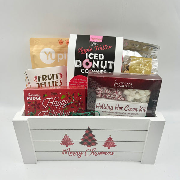  Nestled inside a festive white crate with plaid Christmas trees, this gift is filled with everything for a cozy holiday morning—hot chocolate mix, fluffy pancake mix, decadent fudge, dried fruit, fruit jellies, chocolate-drizzled popcorn, and delicious cookies. It’s the perfect start to a warm and memorable Christmas day.