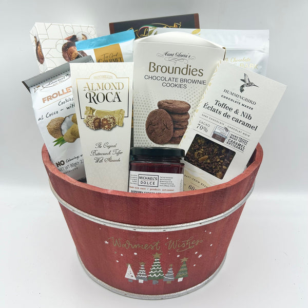  This festive wooden bucket, adorned with Christmas trees, is filled to the brim with rich chocolate indulgences, including a delicious assormtnet of cookies, chocolate toffee crunch, raspberry chocolate jam, chocolate bark. It's the ultimate chocolate lover's dream for a truly sweet holiday season.