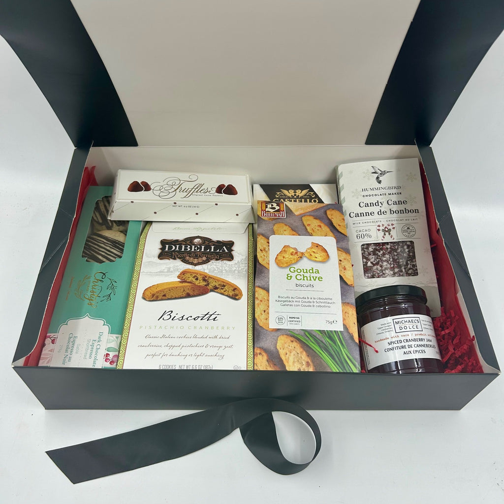 Celebrate the season with a harmonious blend of sweet and savory treats perfect for clients or employees alike. This gift box includes indulgent homemade shortbread, decadent biscotti, creamy gouda bites, luxurious truffles,  festive Hummingbird candy cane chocolate, and locally crafted jam.