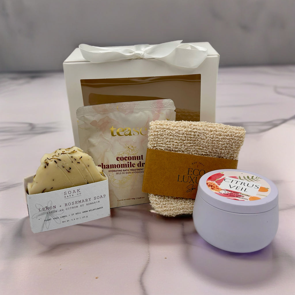 A curated spa gift set , a bath soak, a exfoliating glove, all natural soap and hand-poured candle