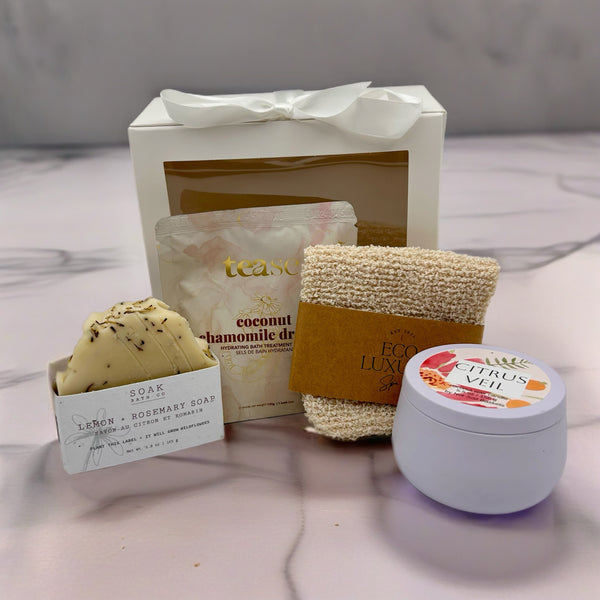 A curated spa gift set , a bath soak, a exfoliating glove, all natural soap and hand-poured candle