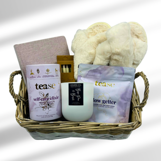 Escape into relaxation with the "Tea, Toes, and Tales" gift basket, thoughtfully curated for moments of indulgence and serenity. Sip on premium tea while sinking your feet into plush, cozy slippers. Let the stress of the day melt away with a luxurious bath soak, and set the mood with the soft glow of a lightly scented, all-natural hand-poured candle. Capture your thoughts, dreams, or stories in a beautiful lavender fabric journal,  using the included pen set