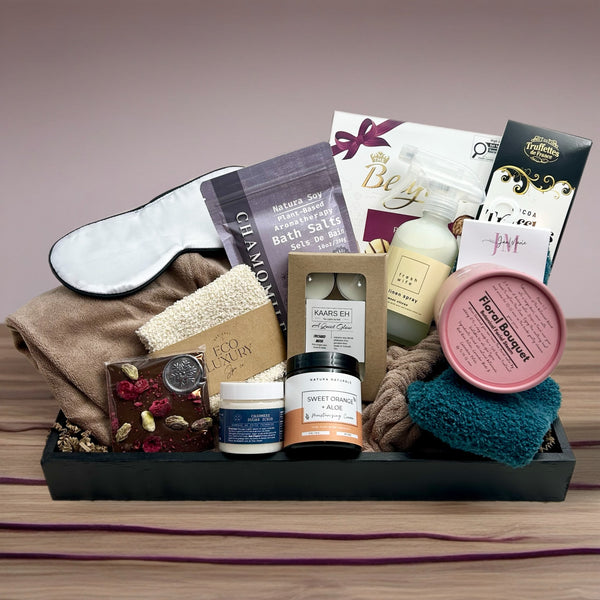 body wrap, eye mask, truffles, facial steam, body cream, sugar scrub, exfoliating glove, cozy socks, linen spray, tea lights, chocolate bar, bath salts, 
