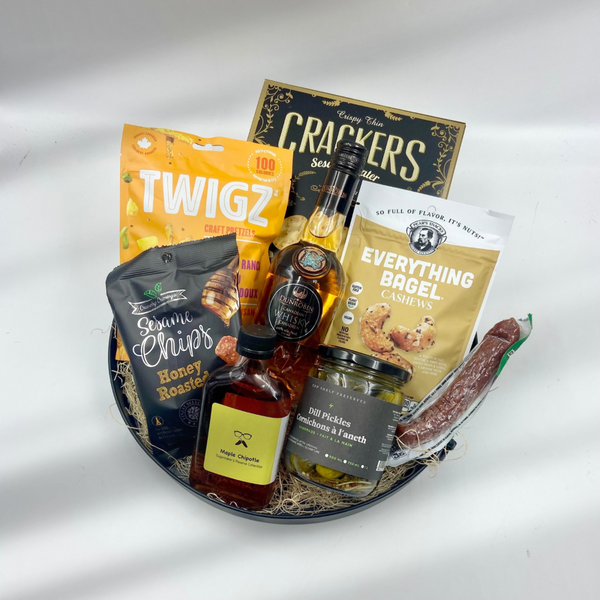 Bring a bold flavor experience with Spirited Spread, a round metal tray packed with savory treats and crafted spirits. Featuring Dunrobin Distilleries vodka for a premium sipping experience, this basket also includes cured sausage, crunchy nuts, pretzels, and crispy chips for the perfect accompaniment. Tangy dill pickles and a dash of chipotle maple syrup add unique flavor twists, making this tray ideal for gatherings or unwinding with friends. 